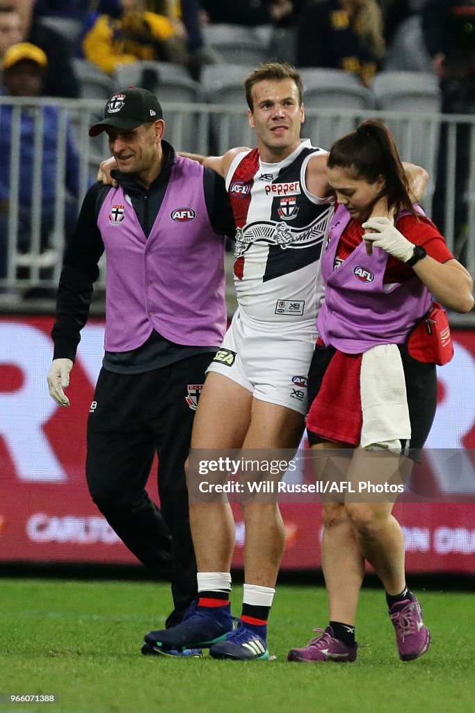 Bailey Rice of the Saints is assisted off the field during the round ...