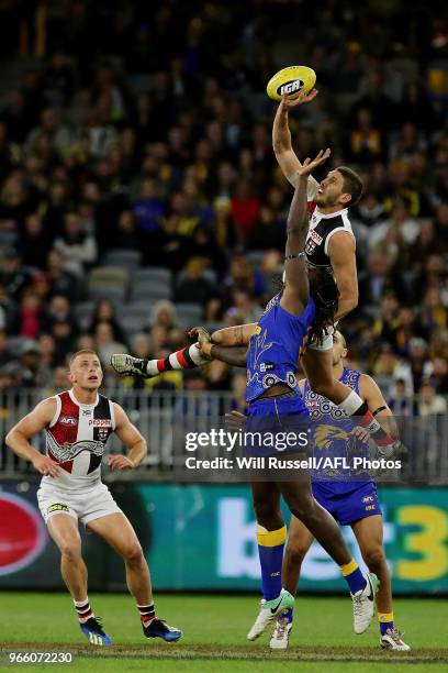 Tom Hickey of the Saints taps the ball during the round 11 AFL match between the West Coast Eagles and the St Kilda Saints at Optus Stadium on June...