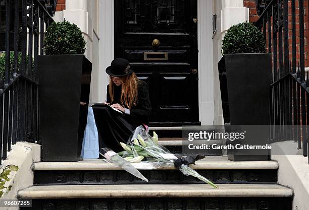 Model Olivia Inge lays a floral tribute outside the home of British Fashion designer Alexander McQueen on February 12, 2010 in London, England. Mr...