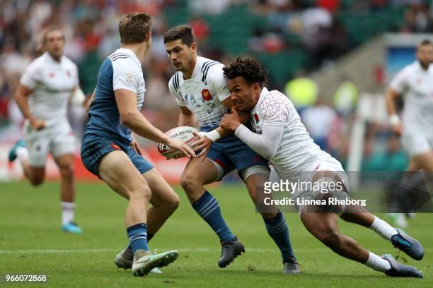 Pierre Boudehent of France and Ryan Olowofela of England in action in their Pool C match during the HSBC London Sevens at Twickenham Stadium on June...