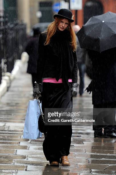 Model Olivia Inge lays a floral tribute outside the home of British Fashion designer Alexander McQueen on February 12, 2010 in London, England. Mr...