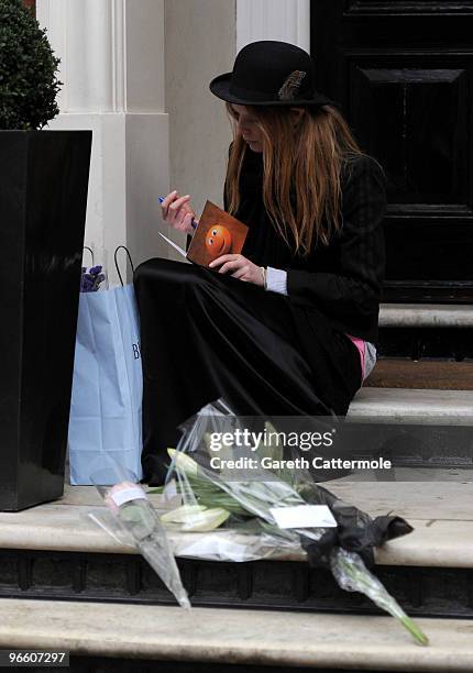 Model Olivia Inge lays a floral tribute outside the home of British Fashion designer Alexander McQueen on February 12, 2010 in London, England. Mr...