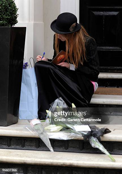 Model Olivia Inge lays a floral tribute outside the home of British Fashion designer Alexander McQueen on February 12, 2010 in London, England. Mr...