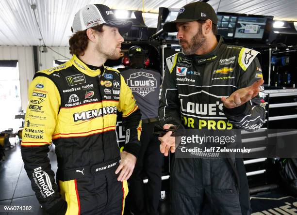 Ryan Blaney, driver of the Menards/Duracell Ford, talks with Jimmie Johnson, driver of the Lowe's for Pros Chevrolet, during practice for the Monster...