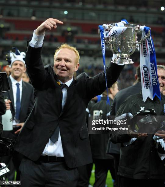 Birmingham City manager Alex McLeish lifts the trophy in celebration after his team win the Carling Cup Final between Arsenal and Birmingham City at...