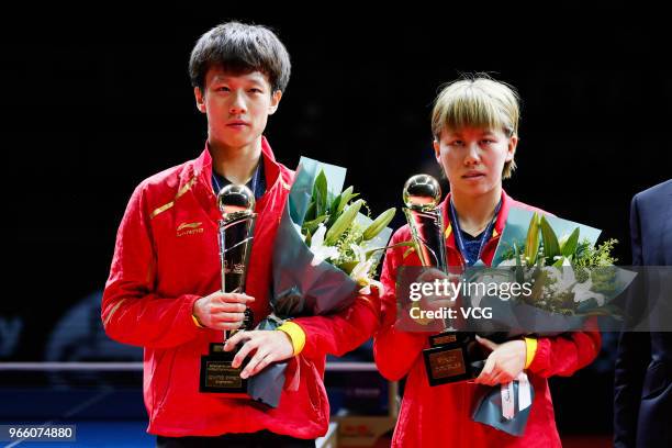 Lin Gaoyuan of China and Chen Xingtong of China pose with trophies after winning the Mixed Doubles final match against Ito Mima of Japan and Masataka...