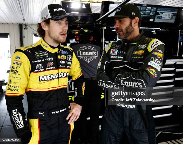 Ryan Blaney, driver of the Menards/Duracell Ford, talks with Jimmie Johnson, driver of the Lowe's for Pros Chevrolet, during practice for the Monster...