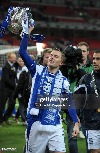 Sebastian Larsson of Birmingham City lifts the trophy in celebration after his team win the Carling Cup Final between Arsenal and Birmingham City at...