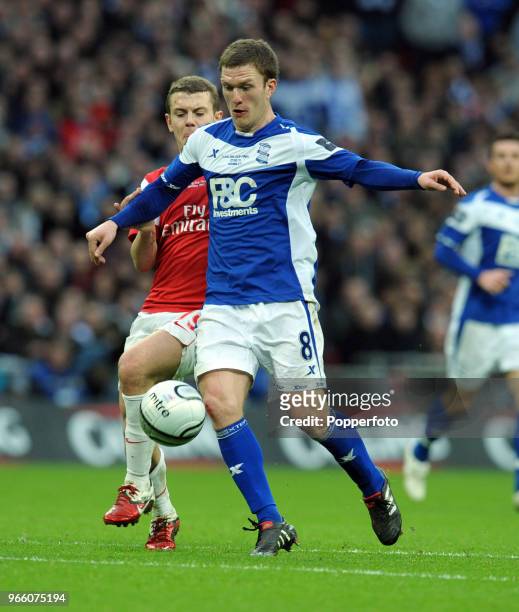 Craig Gardner of Birmingham City is chased by Jack Wilshere of Arsenal during the Carling Cup Final between Arsenal and Birmingham City at Wembley...