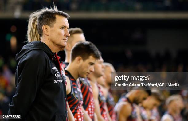 John Worsfold, Senior Coach of the Bombers lines up for the war cry during the 2018 AFL round 11 Dreamtime at the G match between the Essendon...
