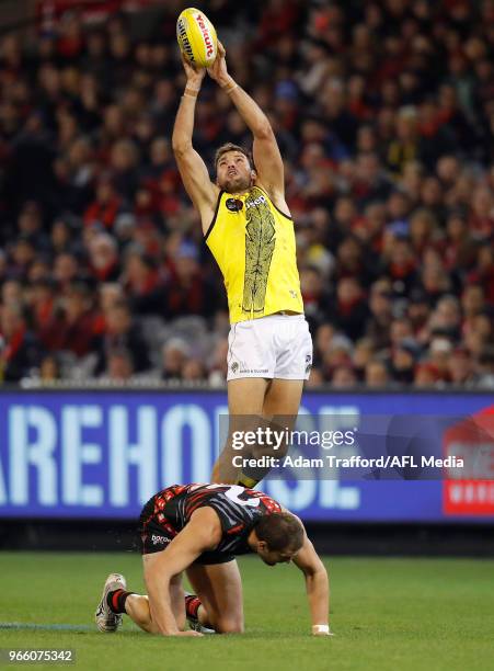 Toby Nankervis of the Tigers attempts to mark over Tom Bellchambers of the Bombers during the 2018 AFL round 11 Dreamtime at the G match between the...