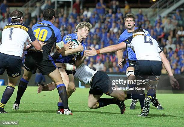 James O'Connor of the Force attempts to push thru the Brumbies defence during the round one Super 14 match between the Western Force and the Brumbies...
