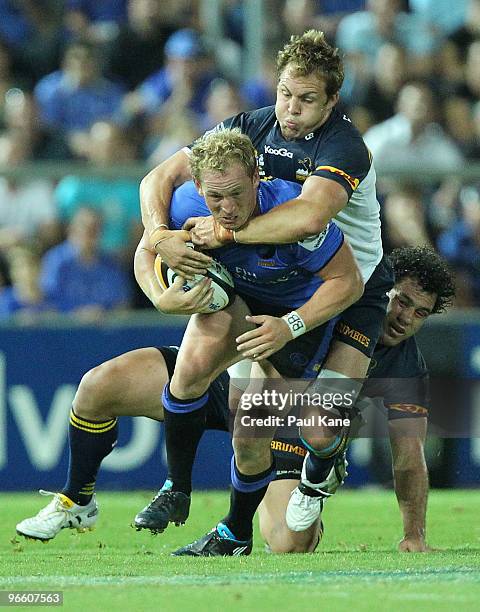 Brett Sheehan of the Force attempts to break a tackle by Stephen Hoiles of the Brumbies during the round one Super 14 match between the Western Force...