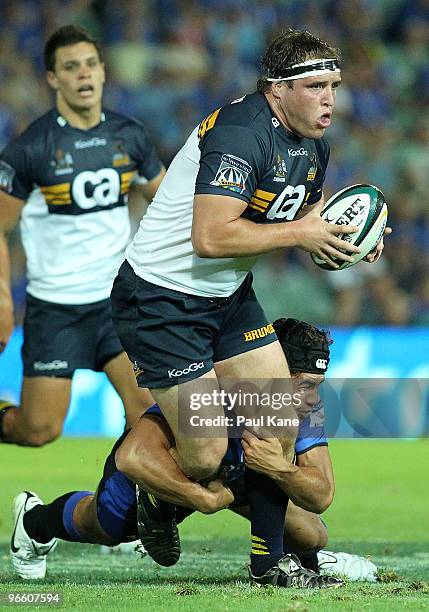 Joshua Tatupu of the Force tackles Ben Alexander of the Brumbies during the round one Super 14 match between the Western Force and the Brumbies at ME...