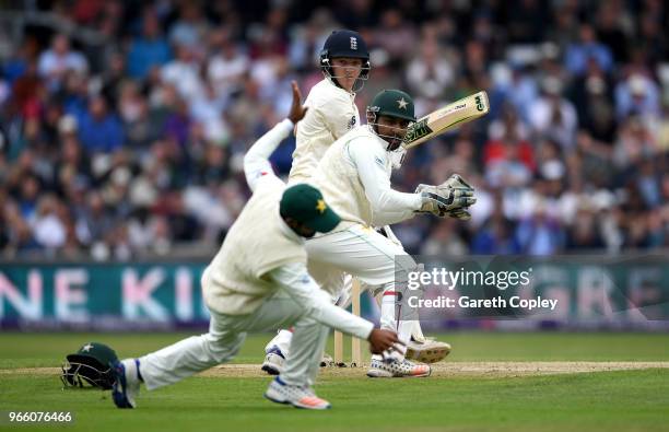 Dominic Bess of England hits past Pakistan wicketkeeper Sarfraz Ahmed and Asad Shafiq during day two of the 2nd NatWest Test match between England...