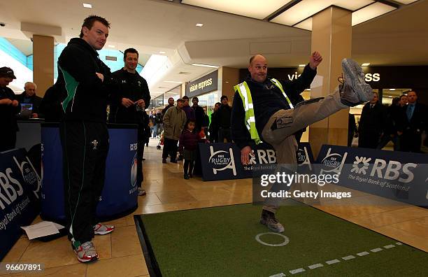 Competitor takes part watched by Wales players Matthew Rees and Ian Gough during the RBS Rugby challenge at St David's Centre on February 12, 2010 in...