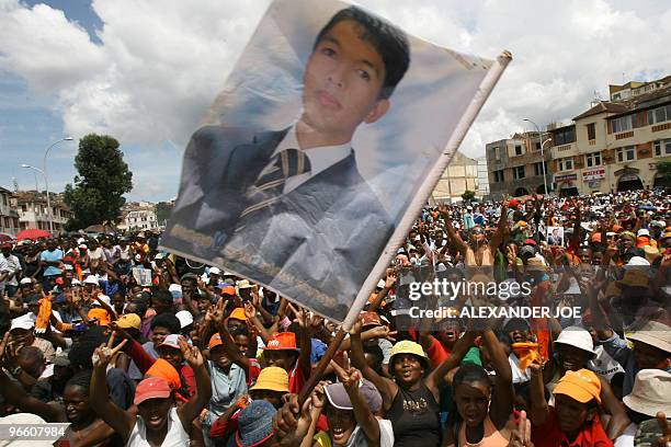 This file photo taken on March 18, 2009 shows supporters wacing a flag of Madagascan opposition leader Andry Rajoelina at a rally in Antananarivo ....