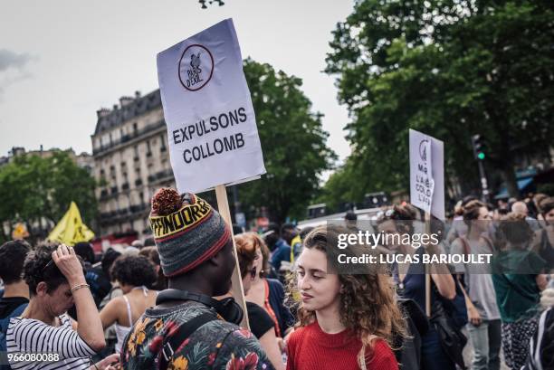 Protester holds a placard reading "Expel [French Interior Minister Gerard] Collomb" during a demonstration calling for the legalisation of...