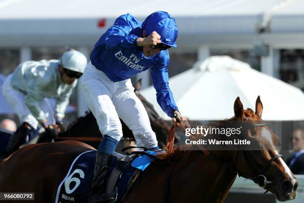 William Buick ridding Masar celebrates winning the Investec Derby race on Derby Day at Epsom Downs on June 2, 2018 in Epsom, England.