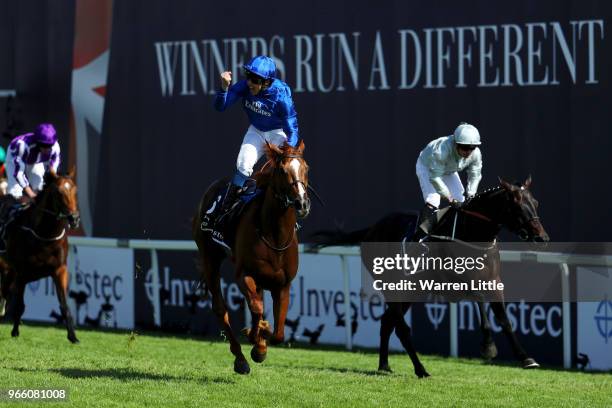 William Buick ridding Masar celebrates crossing the line and winning the Investec Derby race on Derby Day at Epsom Downs on June 2, 2018 in Epsom,...