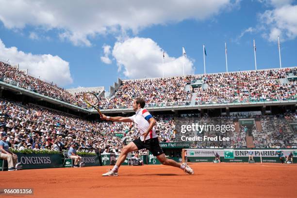 Richard Gasquet of France plays a backhand during his mens singles third round match against Rafael Nadal of Spain during day 7 of the 2018 French...