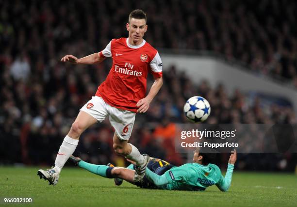 Laurent Koscielny of Arsenal fouls Barcelona's Pedro Rodriguez during the UEFA Champions League round of 16 first leg match between Arsenal and...