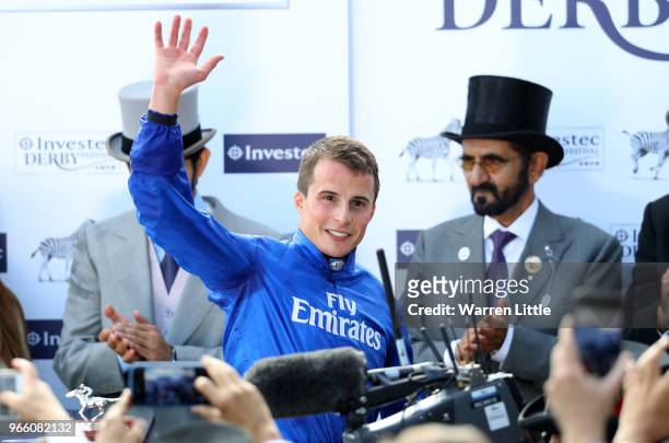 William Buick ridding Masar celebrates winning the Investec Derby race on Derby Day at Epsom Downs on June 2, 2018 in Epsom, England.
