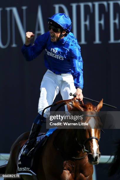 William Buick ridding Masar celebrates crossing the line and winning the Investec Derby race on Derby Day at Epsom Downs on June 2, 2018 in Epsom,...