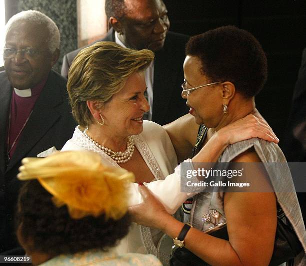 Graca Machel and Elita de Klerk greet each other in Parliament on February 11, 2010 in Cape Town, South Africa.