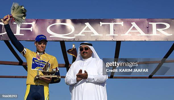 Vacansoleil team rider Wouter Mol of the Netherlands wearing the leader's yellow jersey, celebrates his overall victory on the podium with Sheikh...