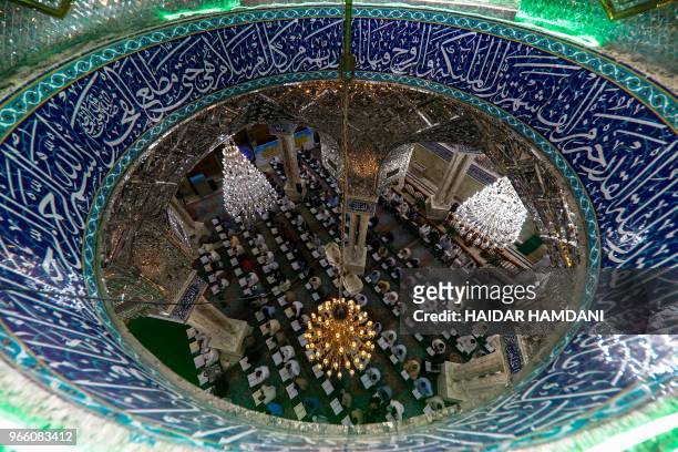 Shiite Muslims participate in a collective Koran reading session during the month of Ramadan, at the Imam Ali Ibn Abi Taleb shrine in the Iraqi holy...