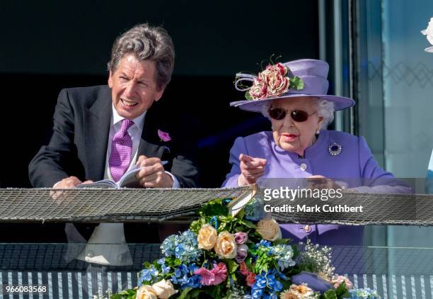 Queen Elizabeth II and John Warren attend the Epsom Derby Festival at Epsom Racecourse on June 2, 2018 in Epsom, England.