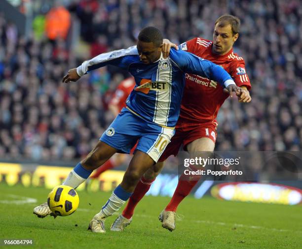 Charles N'Zogbia of Wigan is challenged by Milan Jovanovic of Liverpool during the Barclays Premier League match between Liverpool and Wigan Athletic...