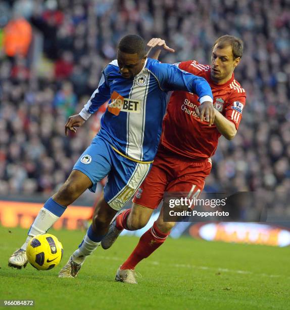 Charles N'Zogbia of Wigan is challenged by Milan Jovanovic of Liverpool during the Barclays Premier League match between Liverpool and Wigan Athletic...