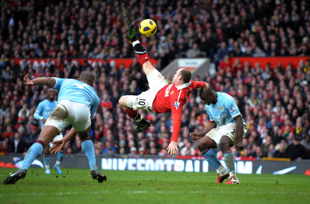 Wayne Rooney of Manchester United scoring a spectacular goal past Manchester City's Vincent Kompany and Micah Richards during the Barclays Premier...