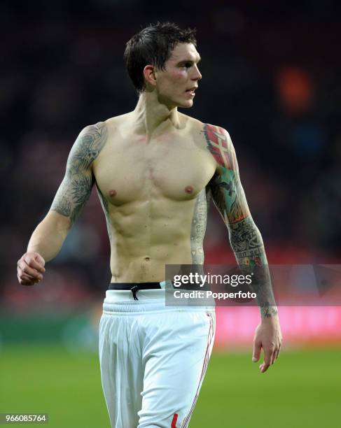 Daniel Agger of Denmark shows off his tattoos whilst leaving the pitch after the final whistle of the international friendly match between Denmark...