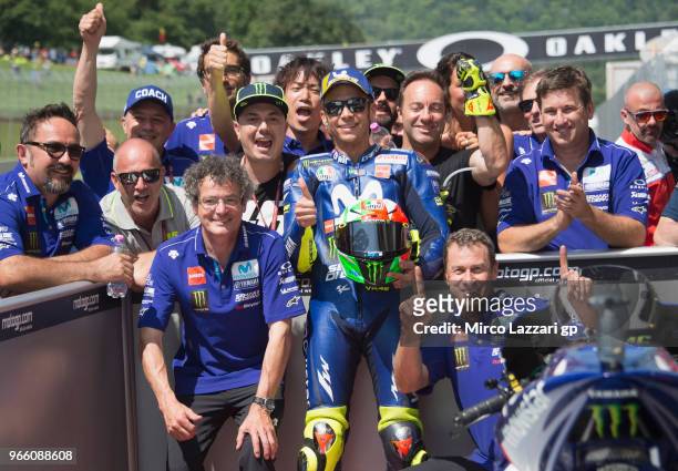 Valentino Rossi of Italy and Movistar Yamaha MotoGP celebrates with team the MotoGP pole position at the end of the qualifying practice during the...
