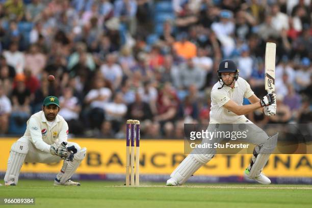England batsman Jos Buttler drives watched by wicketkeeper Sarfraz Ahmed during day two of the second test match between England and Pakistan at...