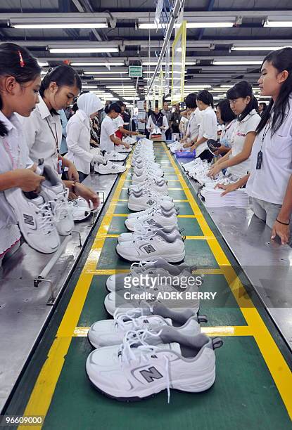 Workers attend a production line at a shoe factory in Tangerang on January 27, 2010. The Indonesian trade minister said that the local shoe industry...