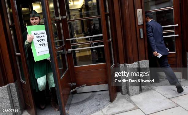 Campaigner from Oxfam dressed as Robin Hood leaves the Goldman Sachs office on February 12, 2010 in London, England. The Robin Hood Tax has been...