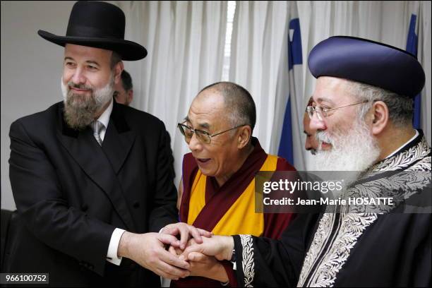 Tibetan spiritual leader, the Dalai Lama, shakes hands with Israel Chief Ashkenaki rabbi Yehuda Metzger , and Israeli chief Sephardic rabbi Shlomo...