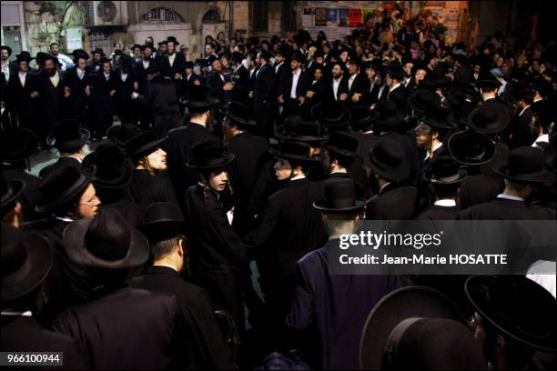 May 15, 2006. Jerusalem. Midnight in the streets of Mea Sharim. A crowd of young men get ready to leave for Meron singing psalms to honor Shimeon Bar...