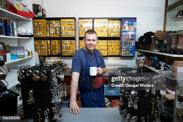 portrait of cobbler and key cutter in his shop. - serralheiro imagens e fotografias de stock