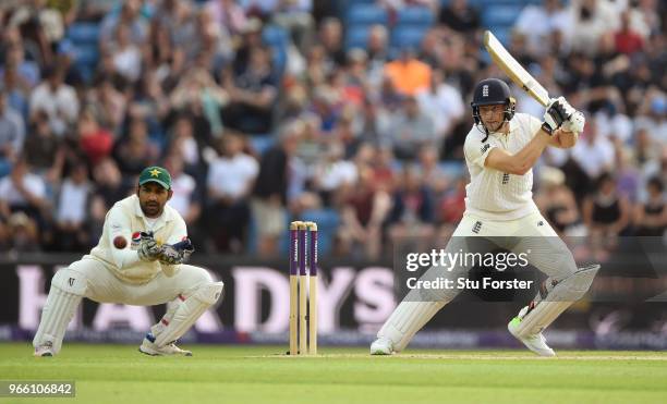 England batsman Jos Buttler cuts a ball watched by wicketkeeper Sarfraz Ahmed during day two of the second test match between England and Pakistan at...