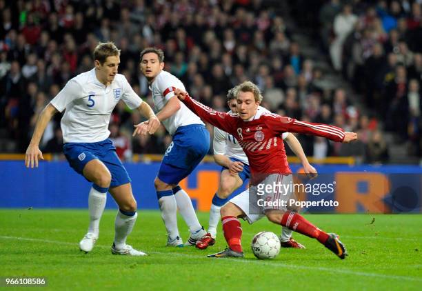 Christian Eriksen of Denmark takes on England's Michael Dawson and Frank Lampard during the international friendly match between Denmark and England...