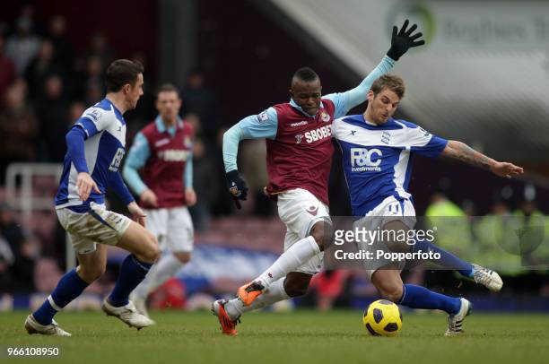 Victor Obinna of West Ham is challenged by David Bentley and Barry Ferguson of Birmingham City during the Barclays Premier League match between West...