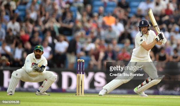 England batsman Jos Buttler cuts a ball watched by wicketkeeper Sarfraz Ahmed during day two of the second test match between England and Pakistan at...