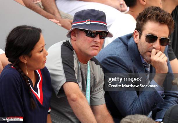 Coaches, David Macpherson and Justin Gimelstob watch on during the mens singles third round match between John Isner of The United States and...