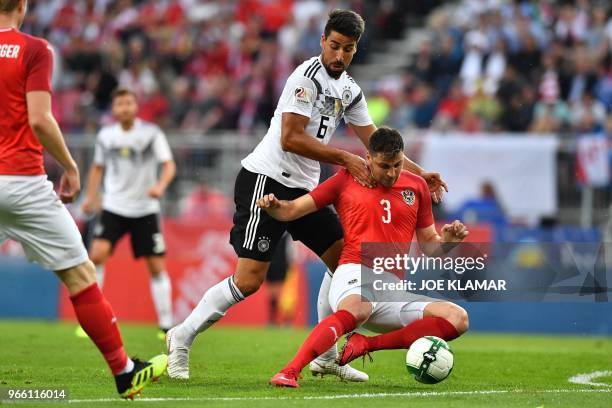 Austria's defender Aleksandar Dragovic and Germany's midfielder Sami Khedira vie for the ball during the international friendly footbal match Austria...