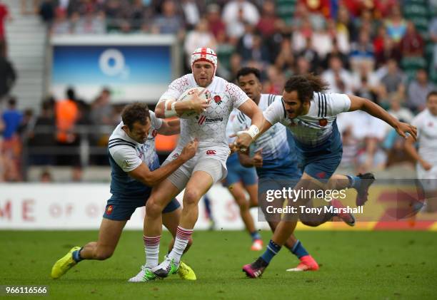 Phil Burgess of England is tackled by Paul Bonnefond and Jonathan Laugel of France during the Pool match between England and France on Day One of the...